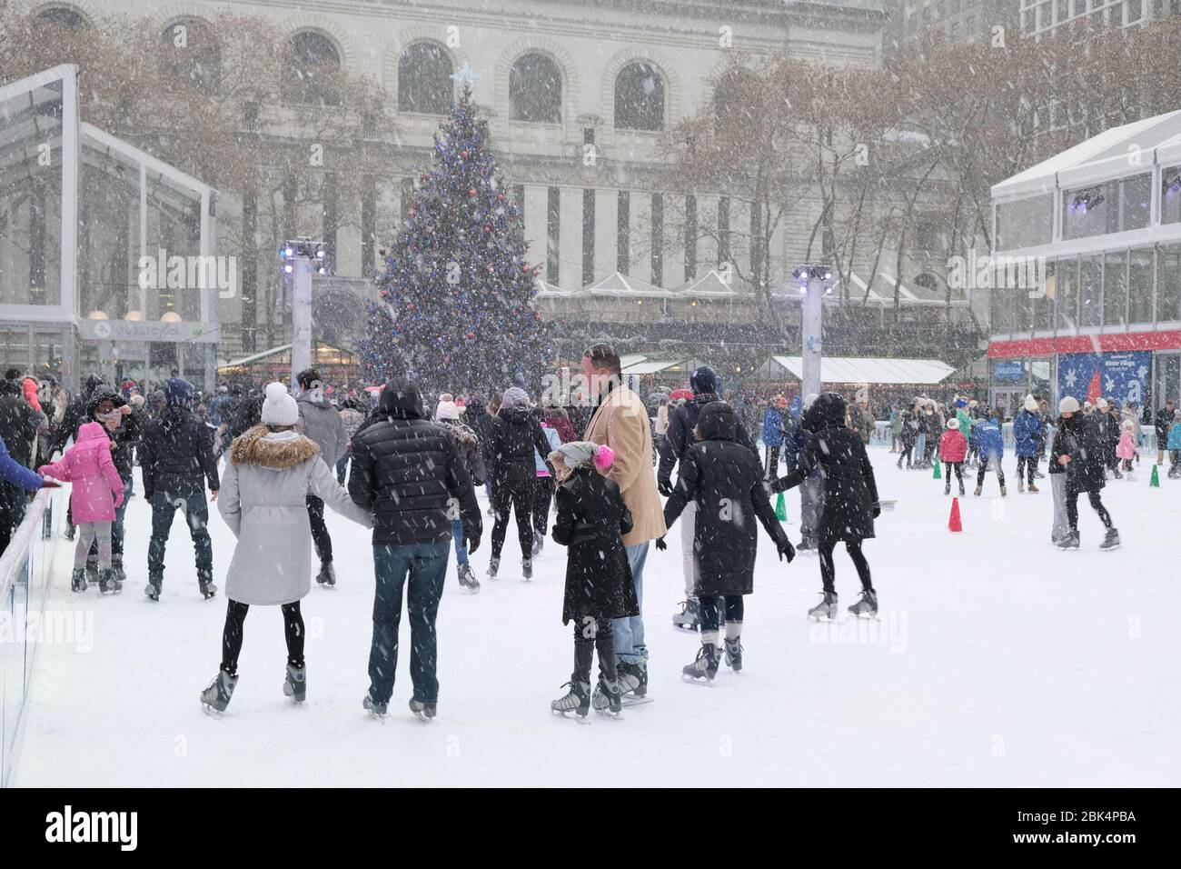 New York, NY/USA- December 2017: The ice rink at the Winter Village at Bryant Park gets very busy during the winter months. Families enjoy themselves Stock Photo