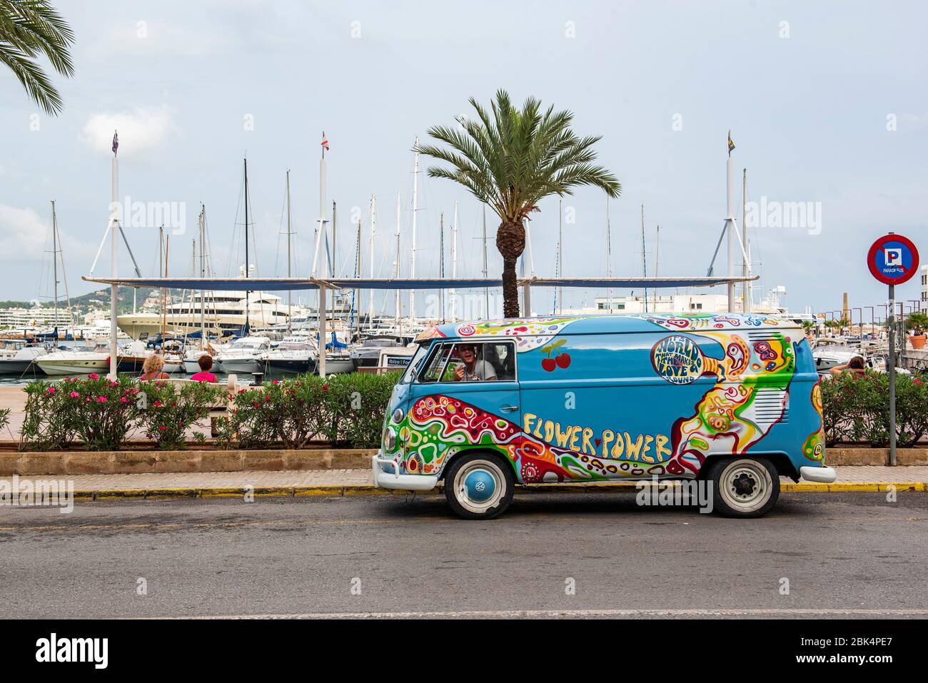 Ibiza, Balearic Islands. Port. An old 1960s style van advertises the hippy style of a 'Flower Power' party held in the most important nightclub Stock Photo