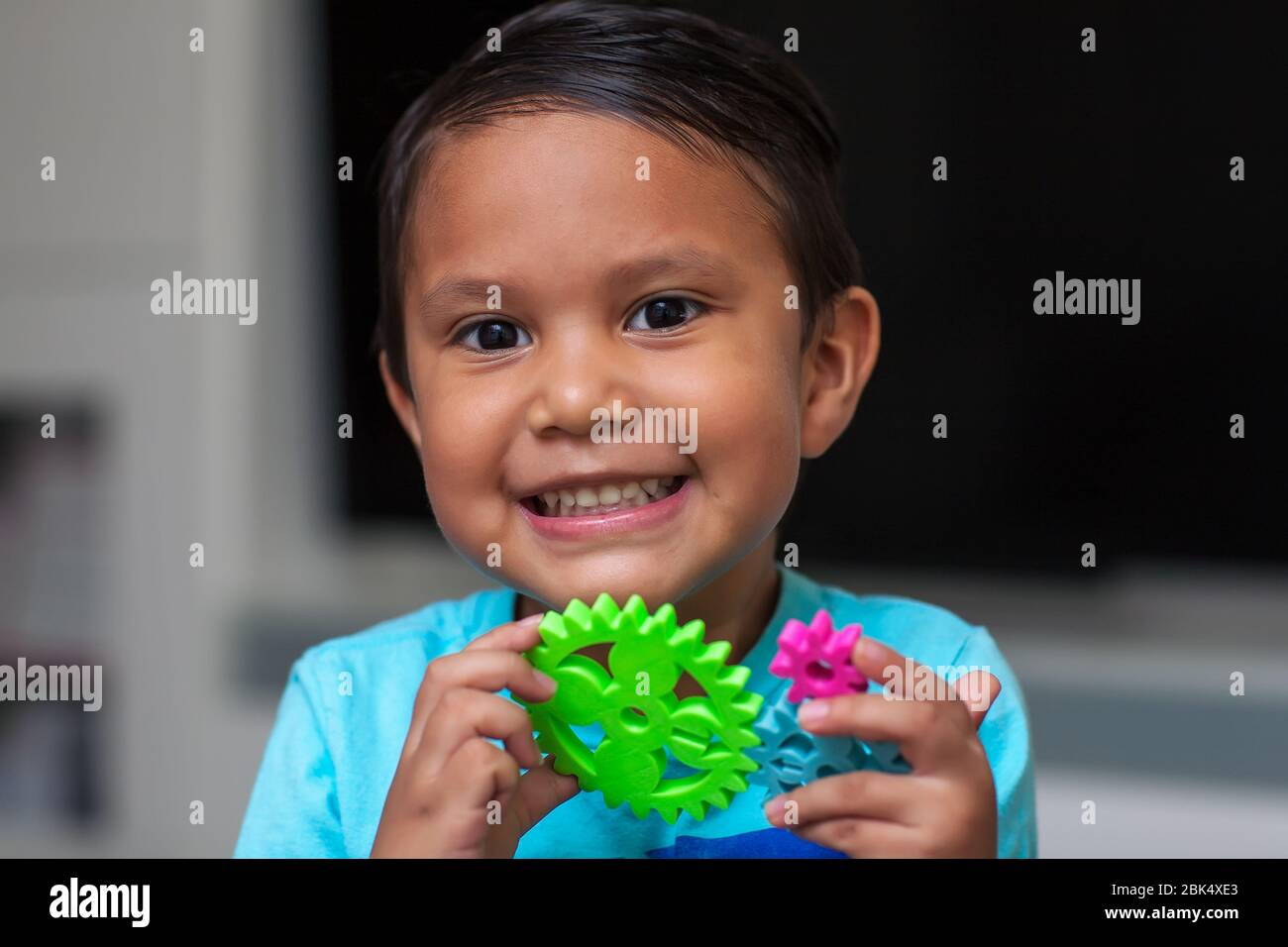 A little boy having fun with gear manipulatives from a engineering class for children. Stock Photo