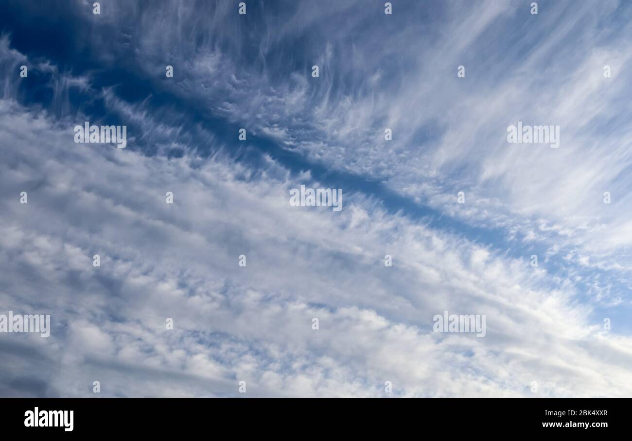 Stunning cirrus cloud formation panorama in a deep blue sky Stock Photo ...