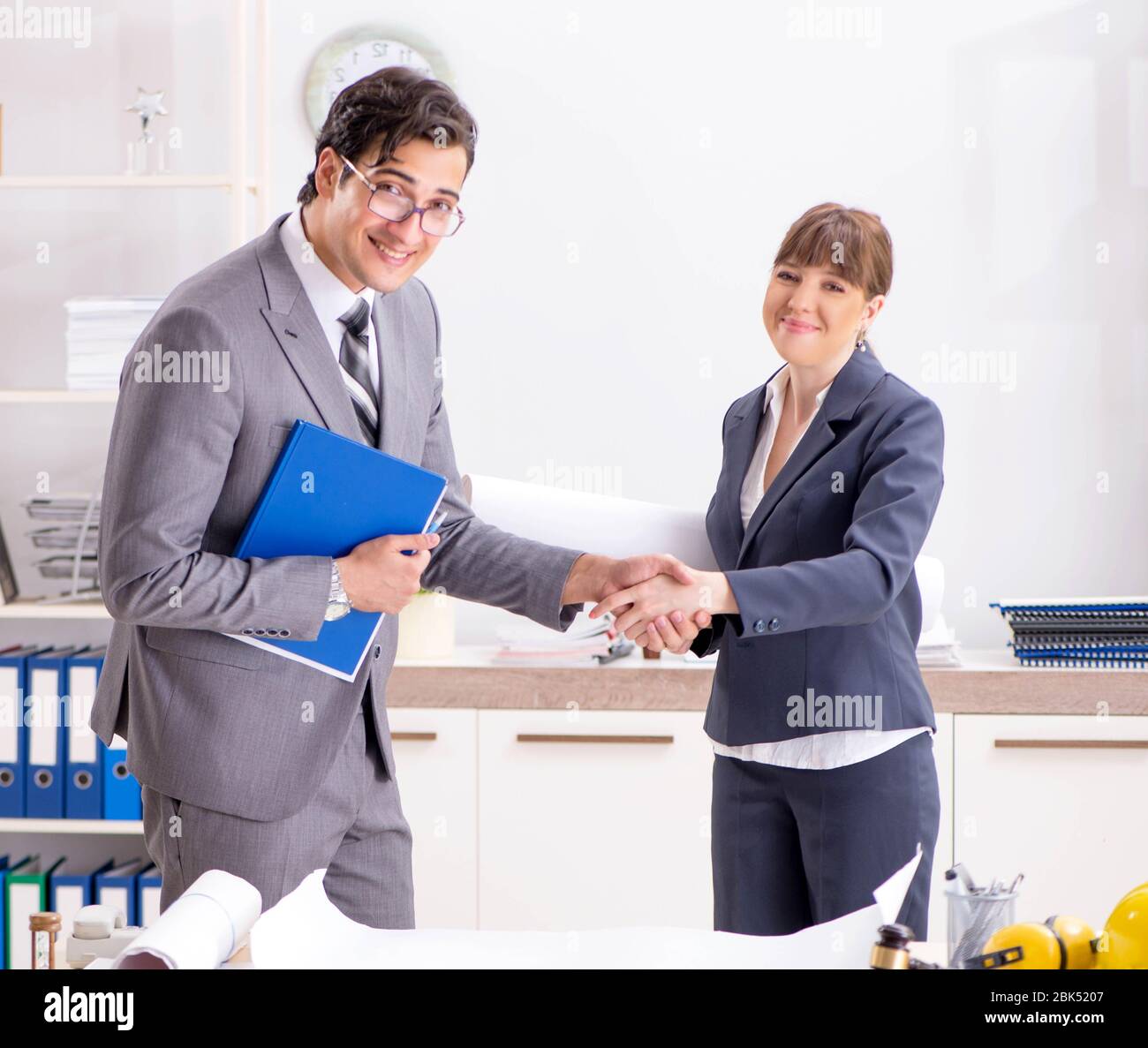 The man and woman discussing construction project Stock Photo