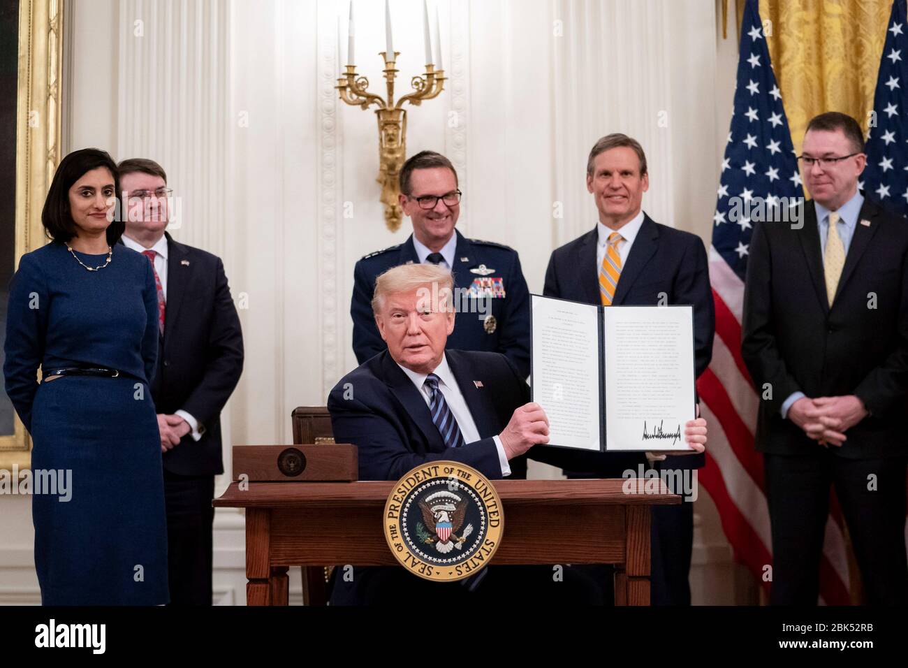 Washington, United States Of America. 30th Apr, 2020. Washington, United States of America. 30 April, 2020. U.S. President Donald Trump, holds up a signed proclamation making the month of May Older Americans Month, during the protecting American Seniors event in the East Room of the White House April 30, 2020 in Washington, DC. Credit: Tia Dufour/White House Photo/Alamy Live News Stock Photo