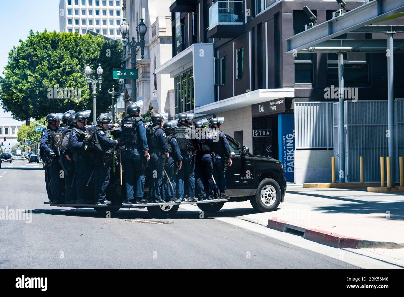 Police swat team preparing for civil unrest ride in police vehicle during a Black Lives Matter protest in Los Angeles during the Coronavirus outbreak Stock Photo
