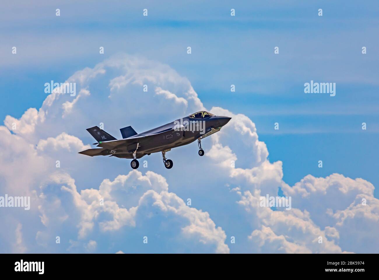 A Lockheed Martin F-35A Lightning II is juxtaposed against a backdrop of spectacular clouds as it starts to land at Hill Air Force Base, Utah. USA. Stock Photo