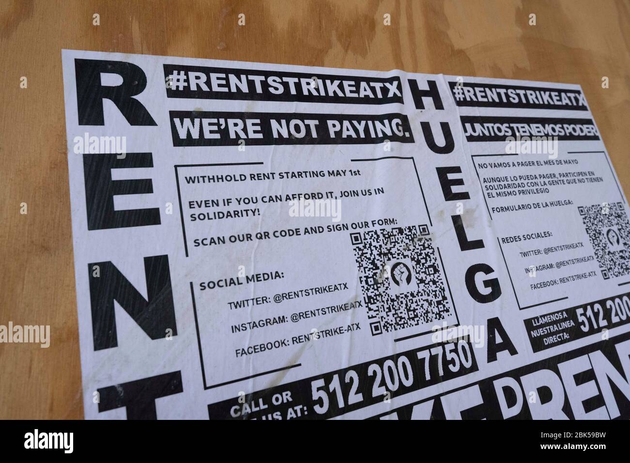 A poster advocating a rent strike on a boarded-up building in downtown's Sixth Street entertainment district. #RentStrikeATX calls for workers who have lost their jobs due to business shutdowns caused by the coronavirus pandemic to withhold paying rent starting May 1 in an effort to get landlords to negotiate with tenants who no longer have an income. Stock Photo