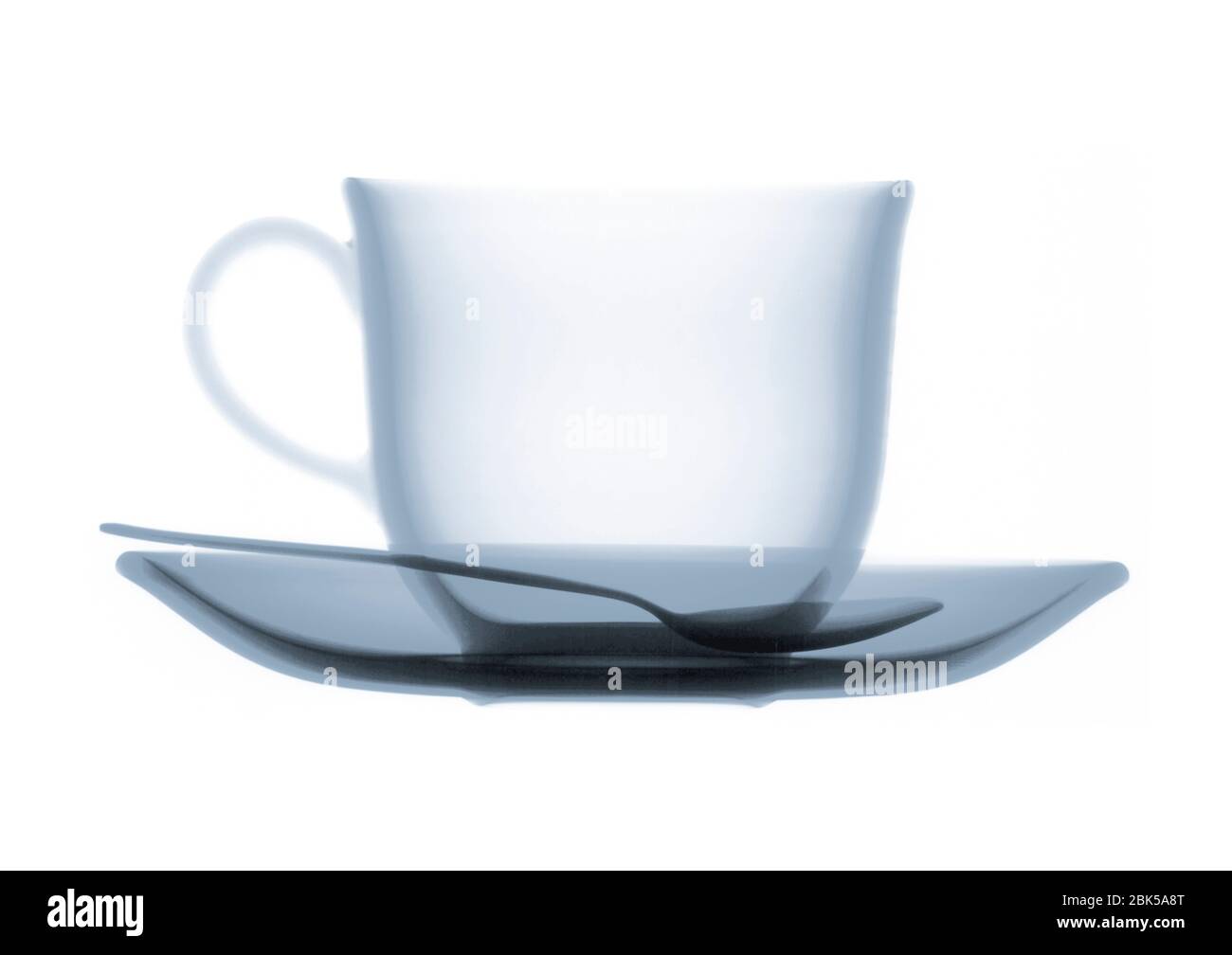 Teacup saucer and teaspoon, coloured X-ray. Stock Photo