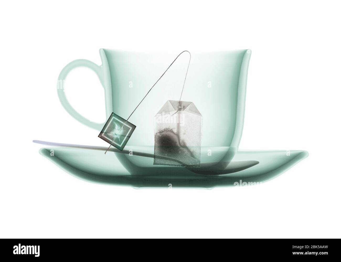 Teacup saucer teaspoon and teabag, coloured X-ray. Stock Photo