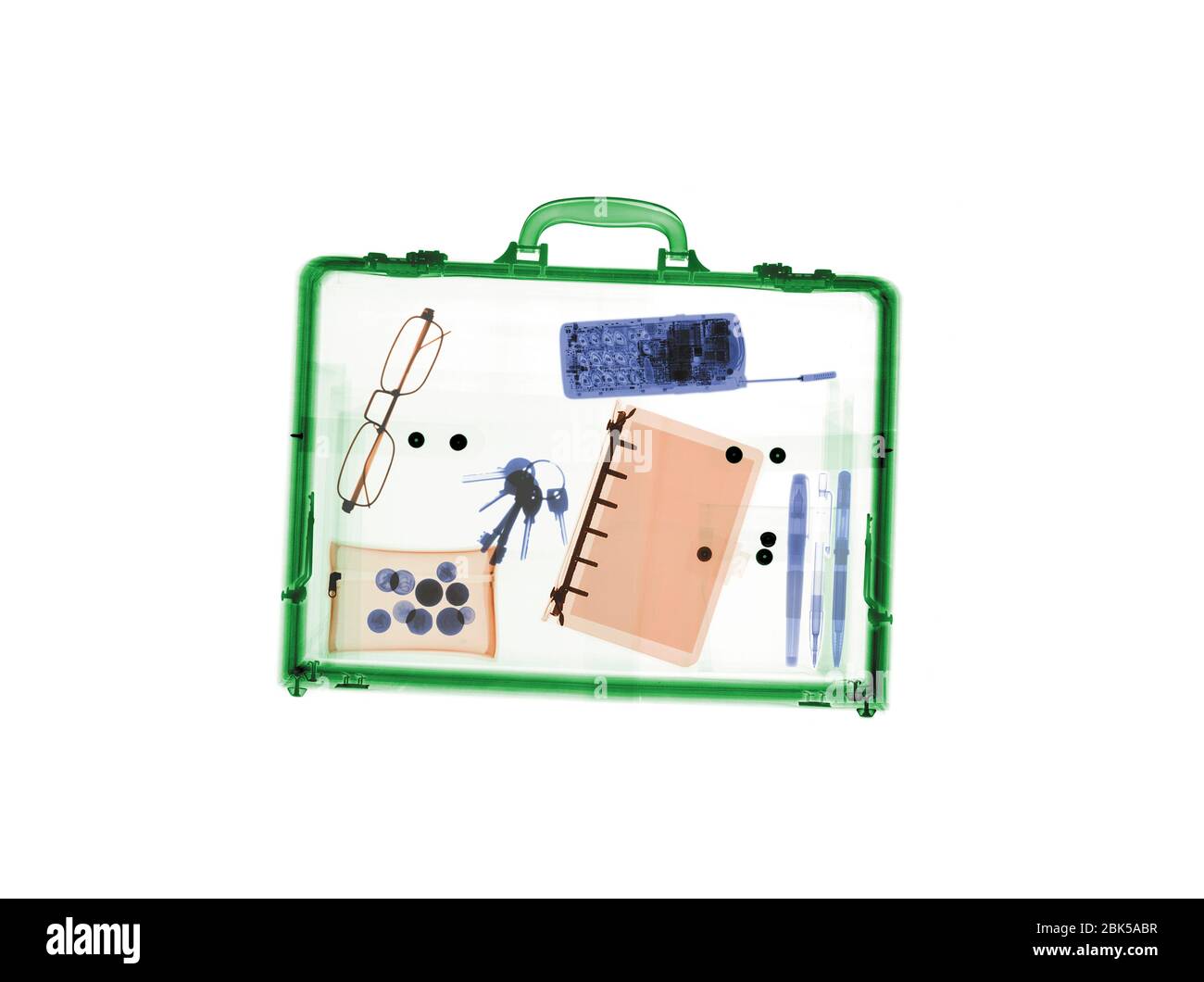 Briefcase with various items, coloured X-ray. Stock Photo