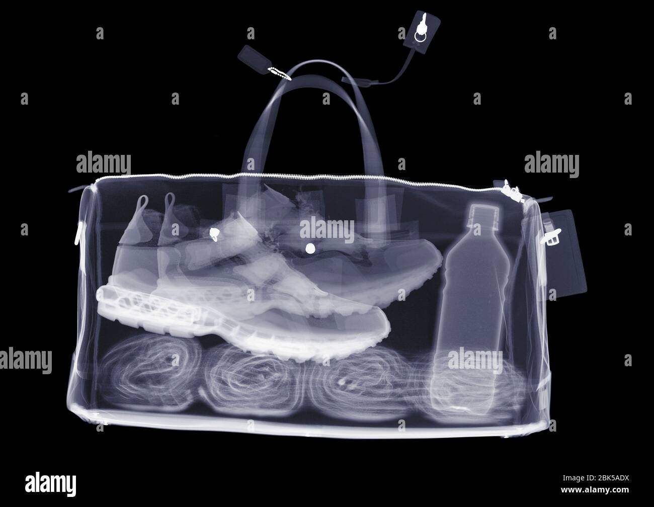 Sports bag with trainers towel and water, X-ray. Stock Photo