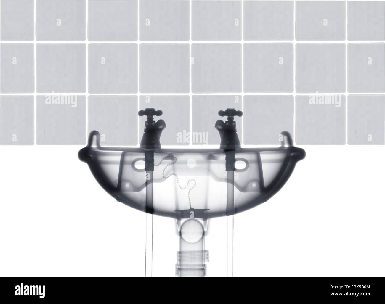 Hot and cold taps with sink and tiles, X-ray. Stock Photo