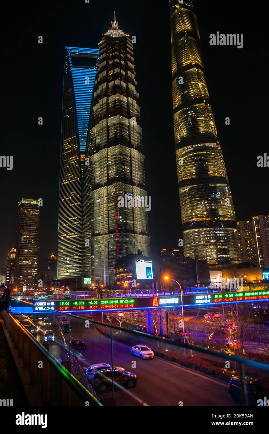 The Shanghai Tower, Jinmao Tower and Shanghai World Financial Center skyscrapers seen at night from the Lujiazui skywalk. Stock Photo