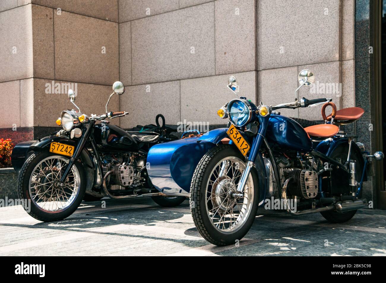 Two gleaming Changjiang 750 motorcycle sidecars outside the Peninsula Hotel awaiting the start of a Shanghai Insiders tour. Stock Photo