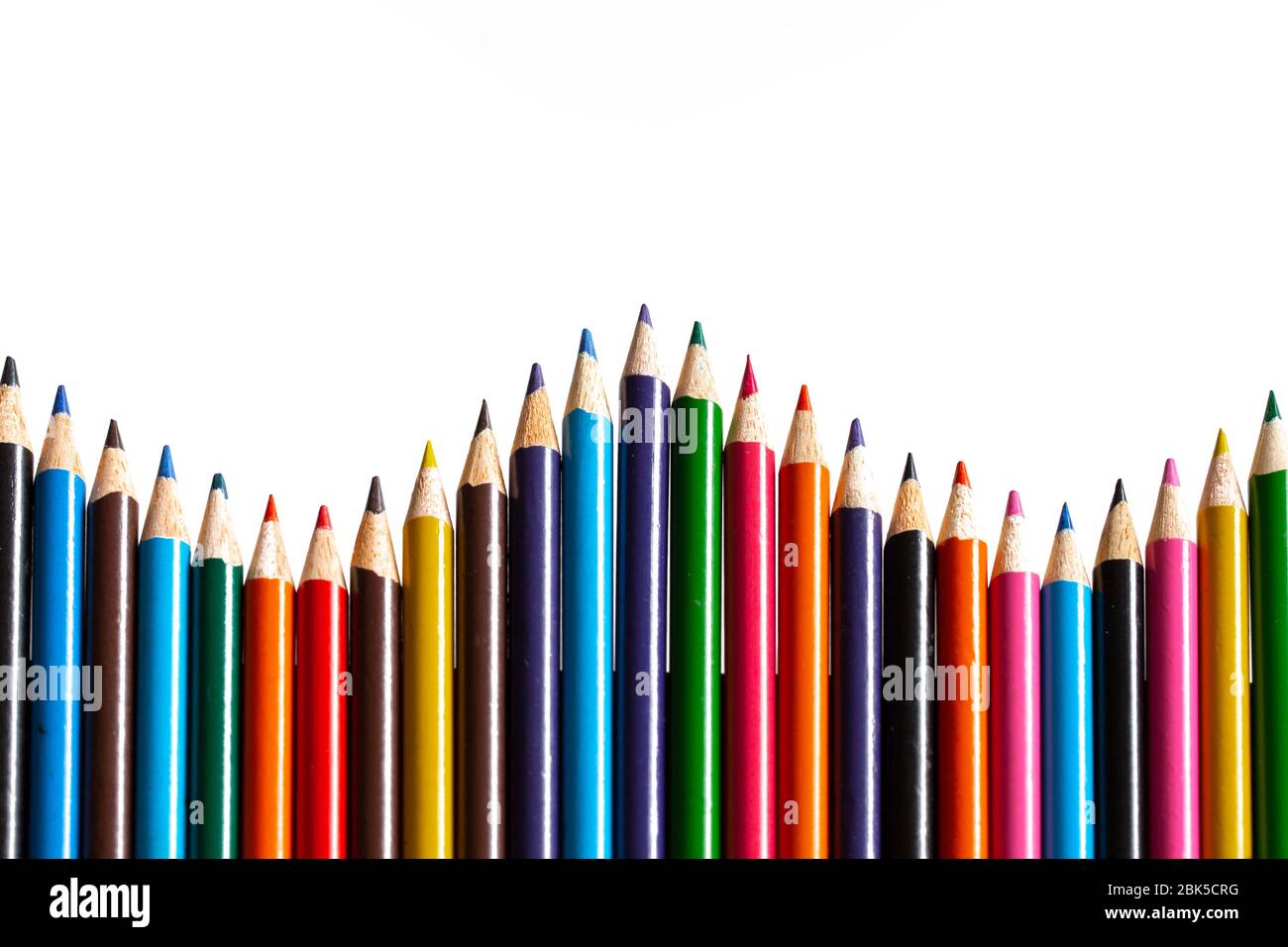 Multi colour pencils arranged on a white background. Copy space Stock Photo