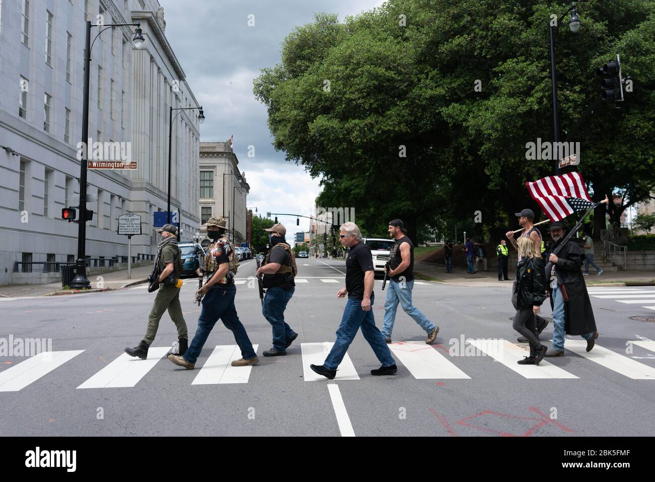 Raleigh, NC, USA. 1st May, 2020. Handful of armed protesters gather in Raleigh to promote free speech and gun rights.About a dozen demonstrators marched Friday afternoon around the area of the Old Capitol, Legislative Building and Executive Mansion. Several had visible firearms. Credit: Mehmet Demirci/ZUMA Wire/Alamy Live News Stock Photo