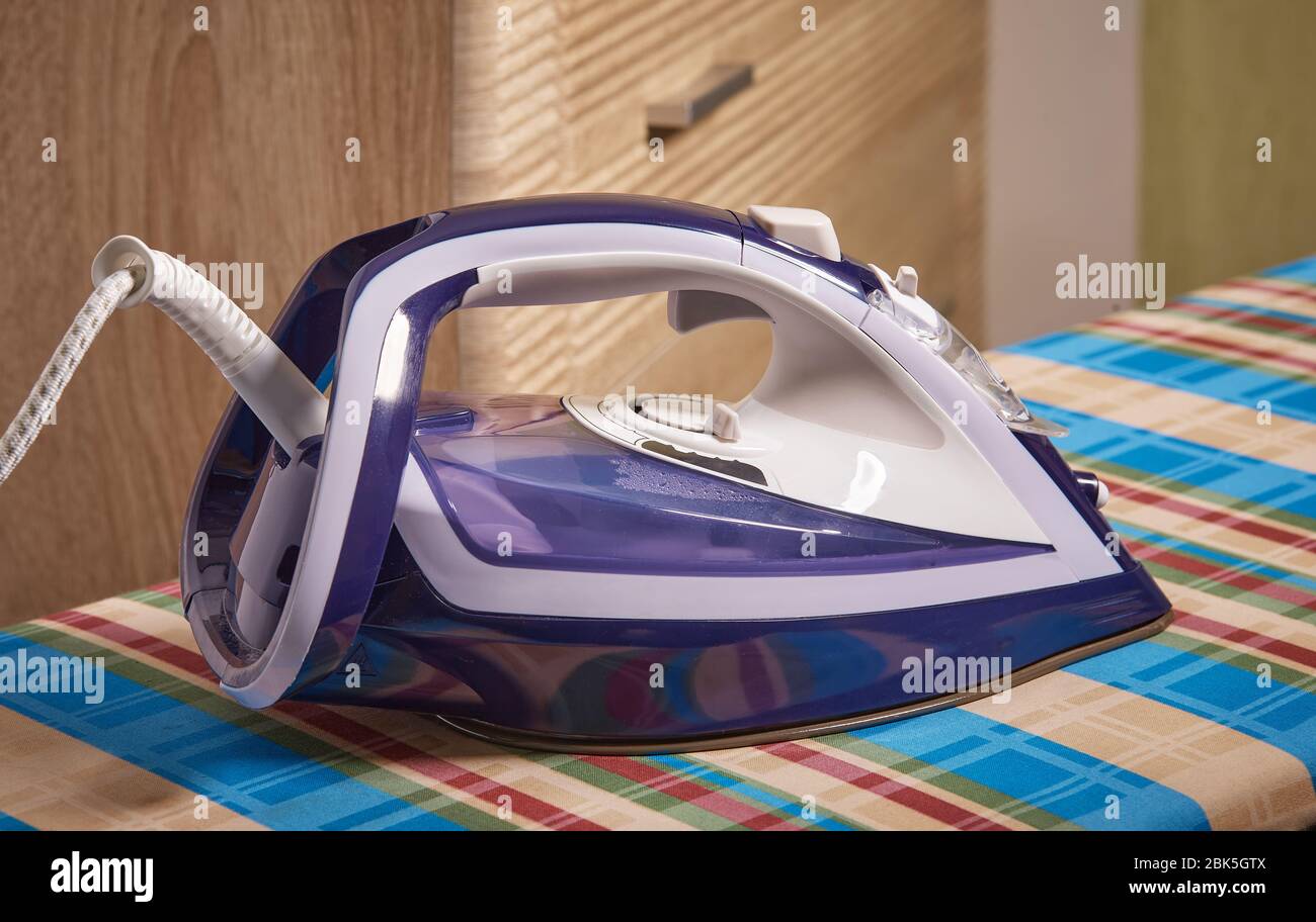 Modern and functional iron on an Ironing Board Stock Photo Alamy