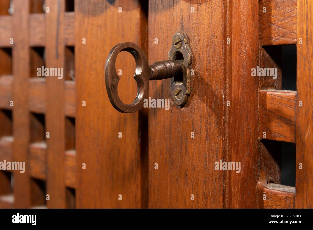 An antique key in an old wooden cupboard Stock Photo
