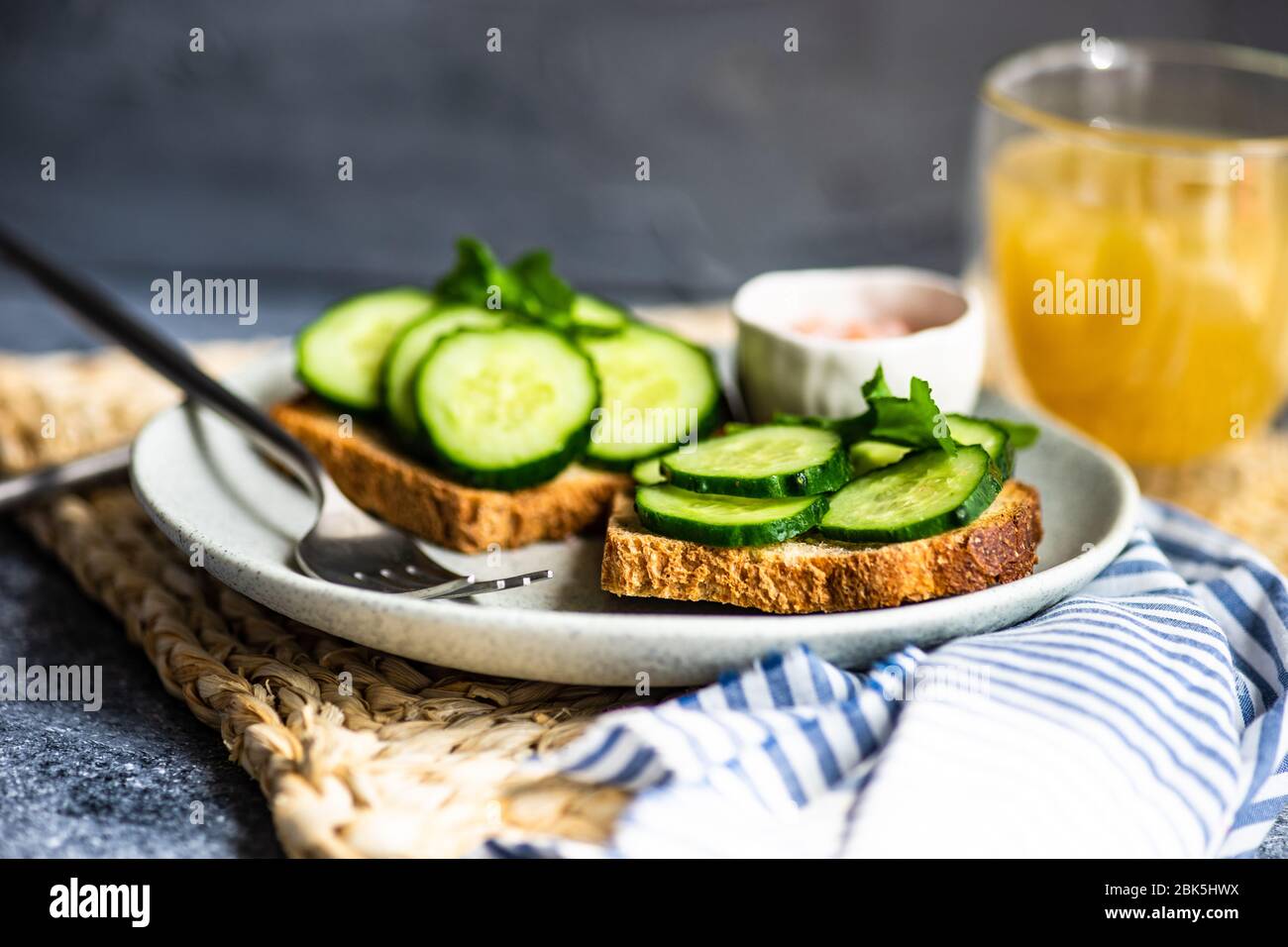 Healthy lunch concept with toasts with organic cucumber, rocket herb ...