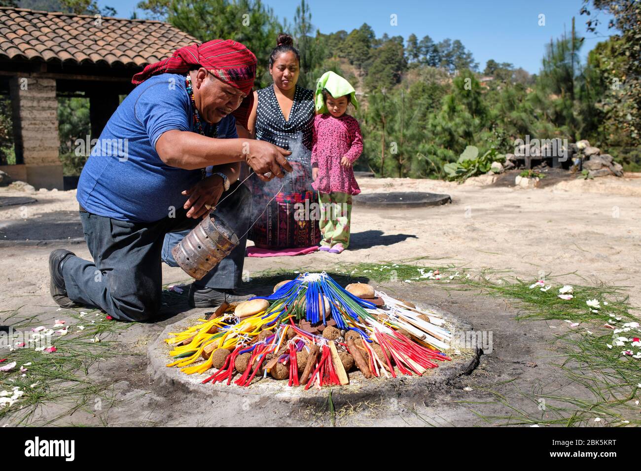 Shaman performing a Mayan healing ceremony for a family on the top of ...