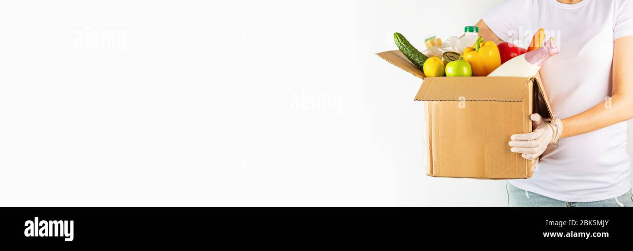 Donation box with various smart food on white background with copy space. Mockup, web banner. Food donations or food delivery service concept. Online Stock Photo