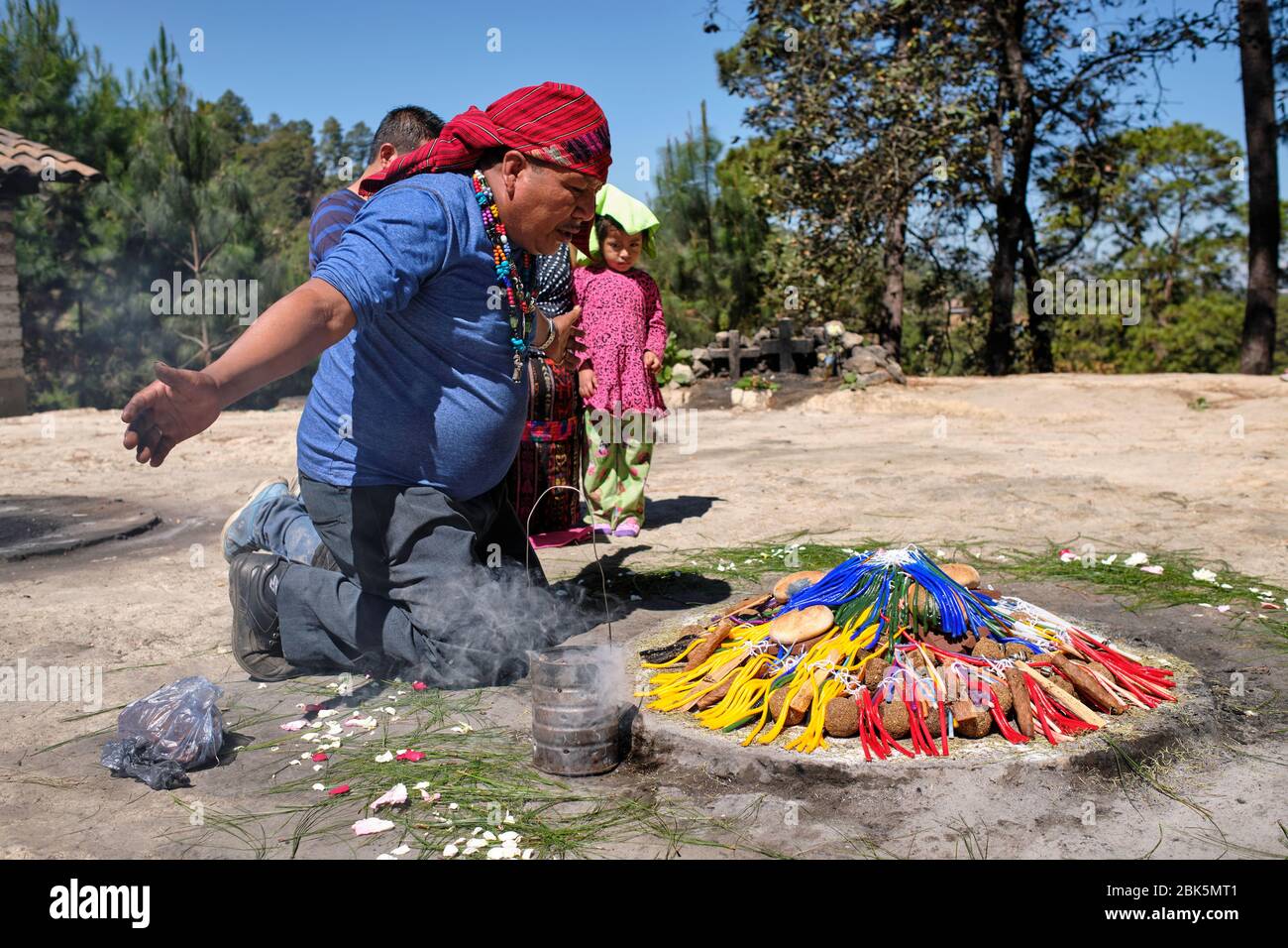 Shaman performing a Mayan healing ceremony for a family on the top of ...