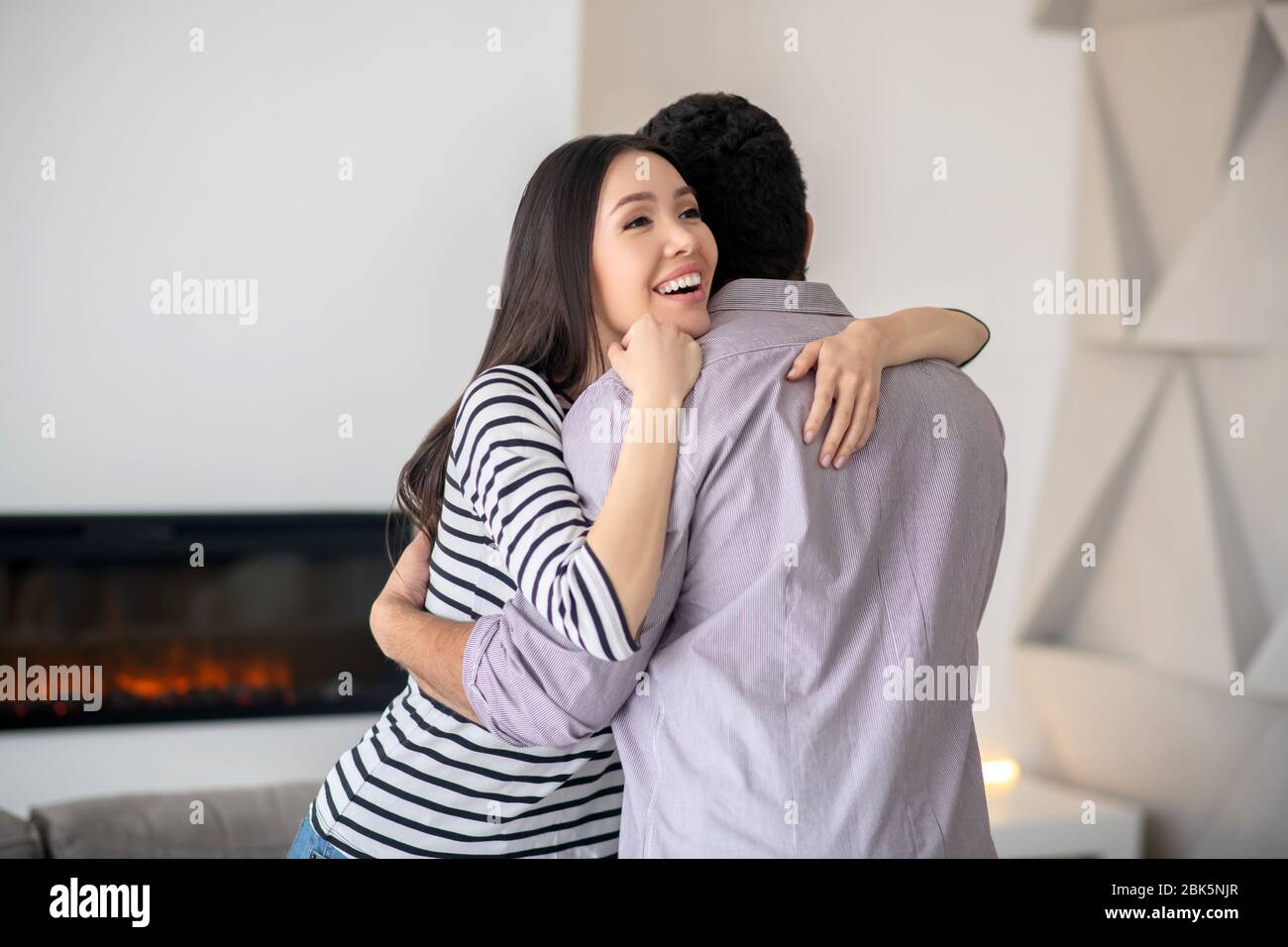 Happy smiling young woman hugging her husband Stock Photo - Alamy