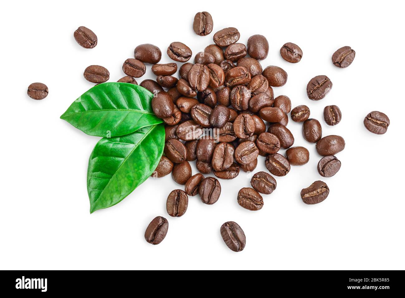 Heap of roasted coffee beans with leaves isolated on white background ...