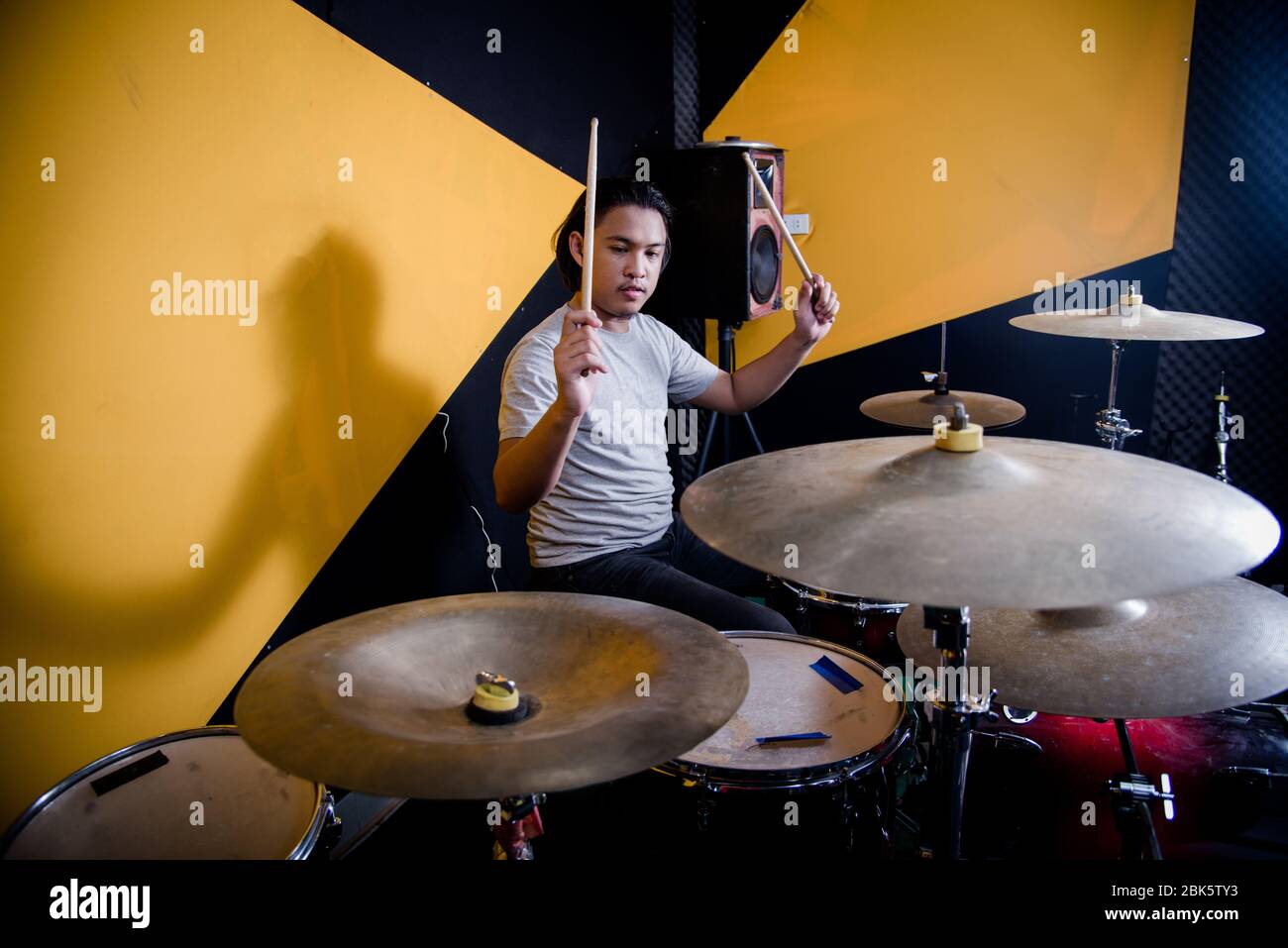 Man recording music on drum set in studio Stock Photo - Alamy
