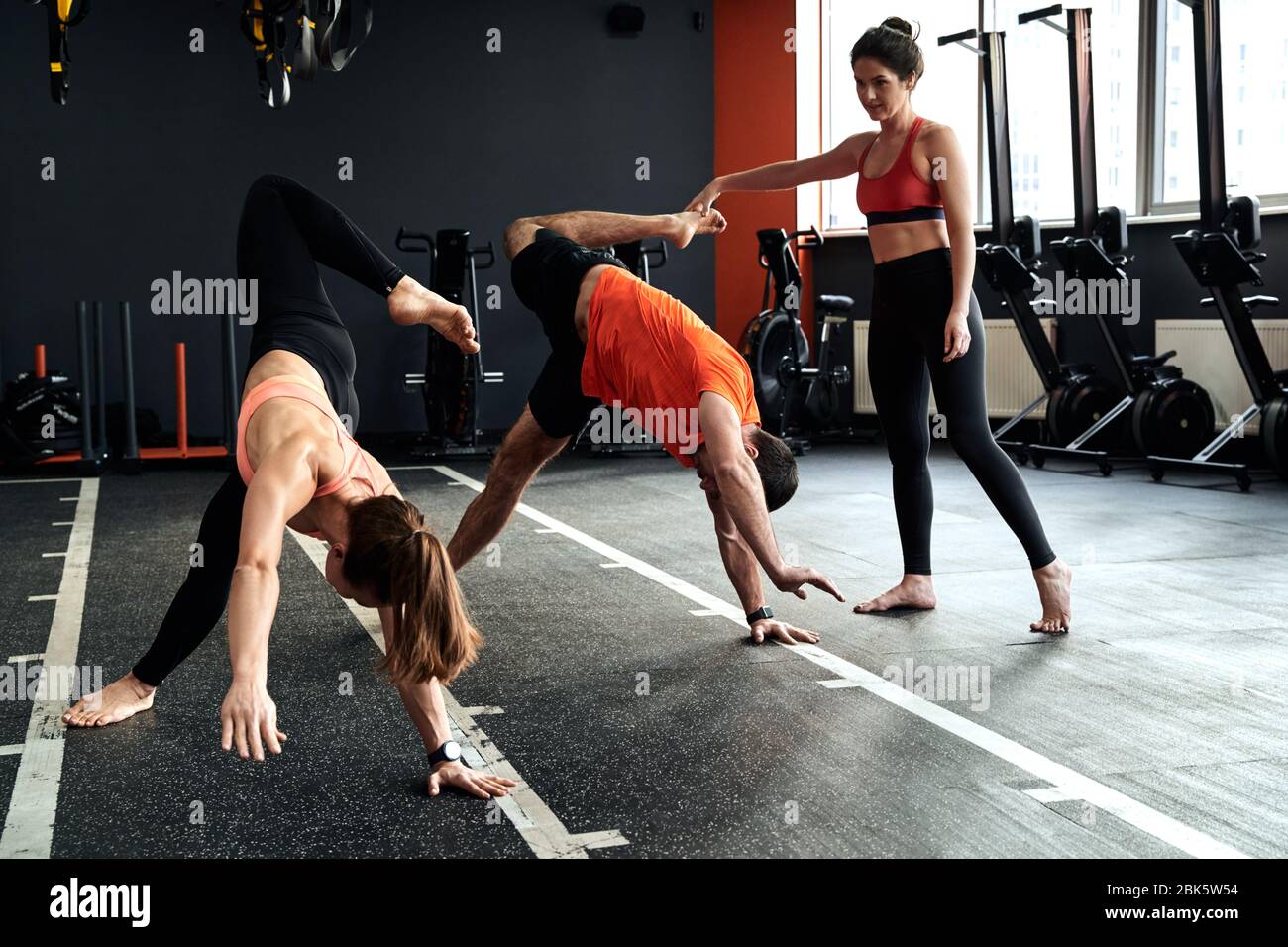 Group of young adult athletes and trainer using animal flow session, making scorpio position Stock Photo - Alamy Group of young adult athletes and trainer using animal flow session, making scorpio position Stock Photo - Alamy
