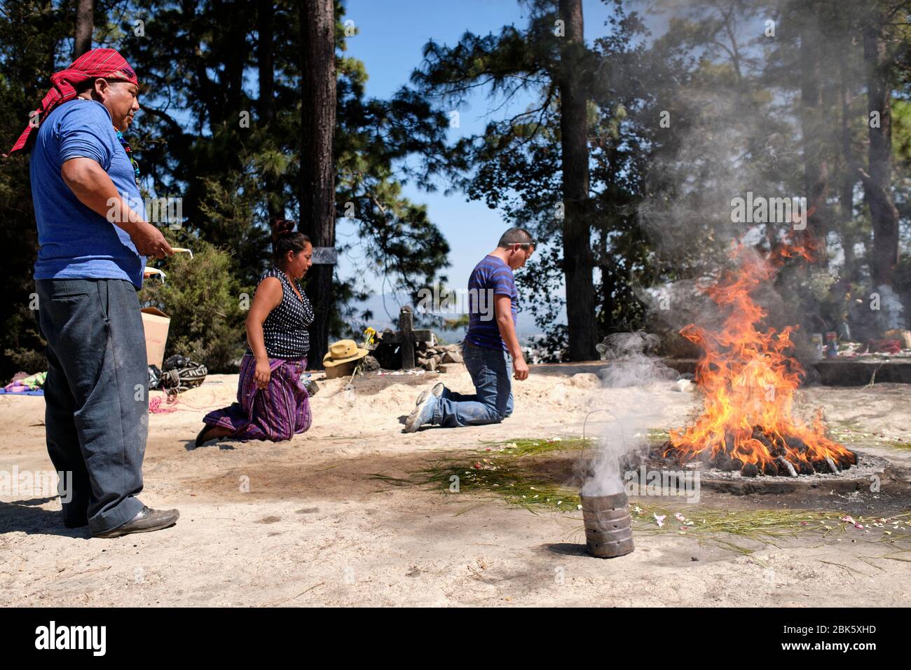 Shaman performing a Mayan healing ceremony for a family on the top of ...