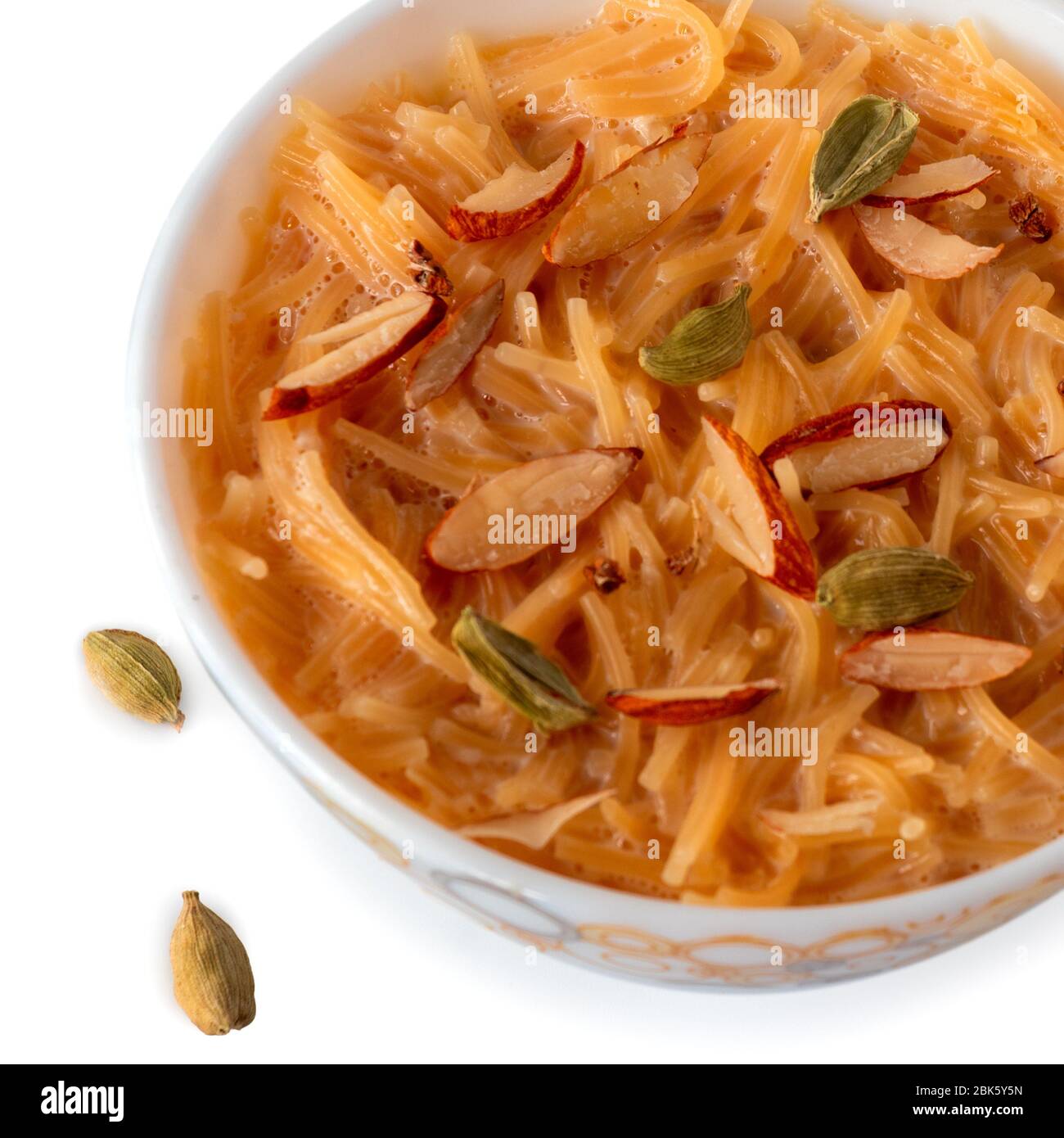 Vermicelli dessert, popular sweet dish know a kheer made with milk and garnish with dry fruits isolated on white background, served in bowl. Selective Stock Photo