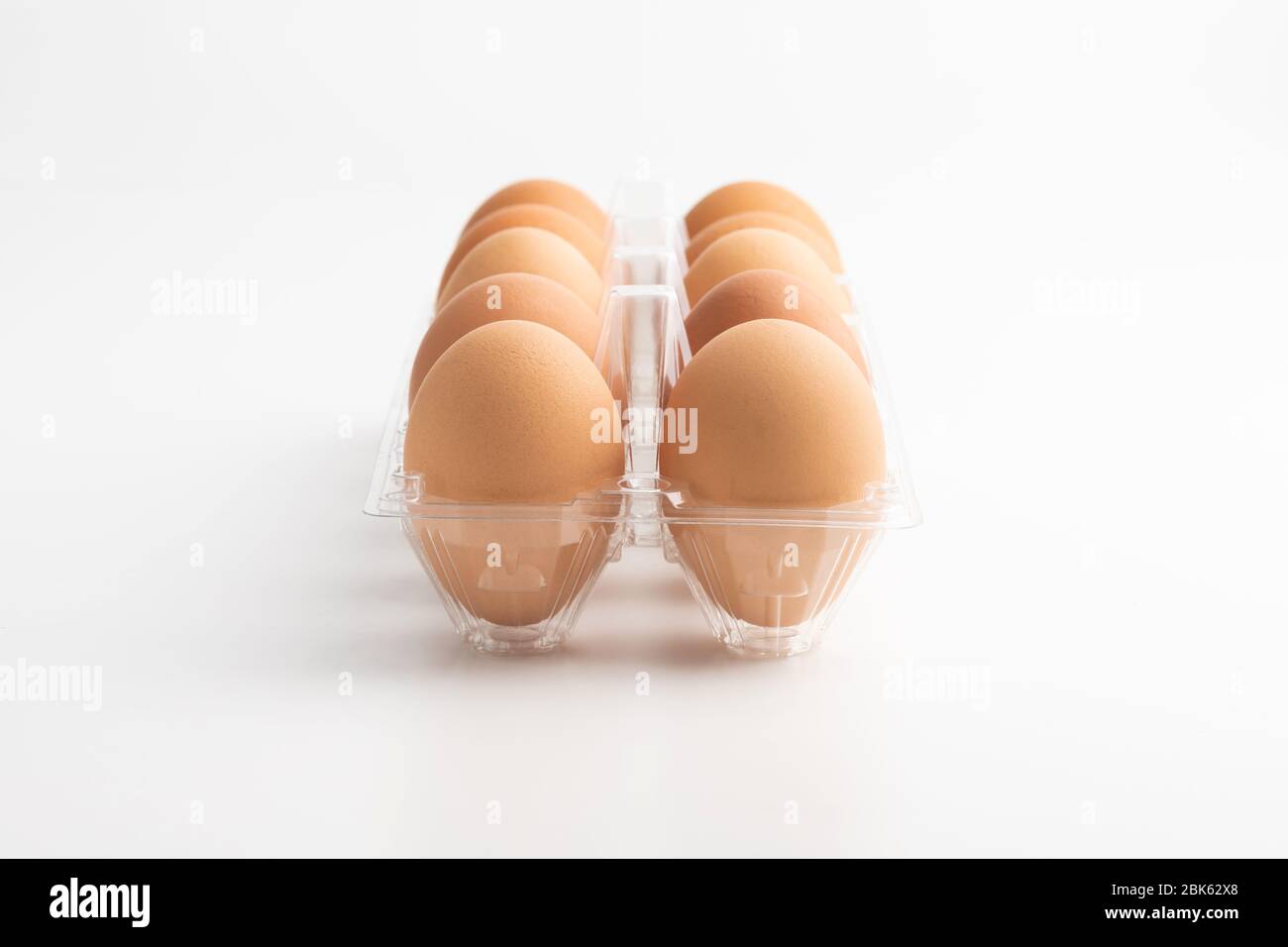Eggs in a clear box on the white background. Stock Photo