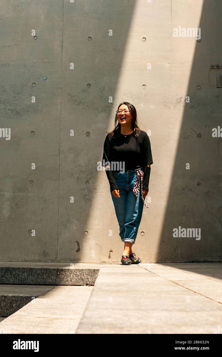 A young Chinese woman models in a ray of light at the Long Museum West Bund, Shanghai, China. Stock Photo