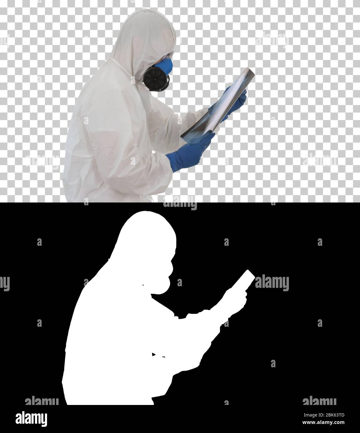 Doctor in protective suit looking at lungs x-ray while walking, Alpha Channel Stock Photo