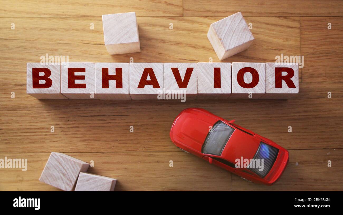 Behavior Word In Wooden Cube and red toy car. Child behavior ...
