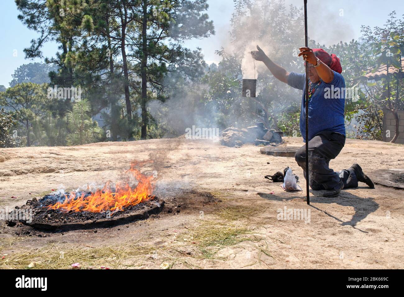 Shaman performing a Mayan healing ceremony for a family on the top of ...