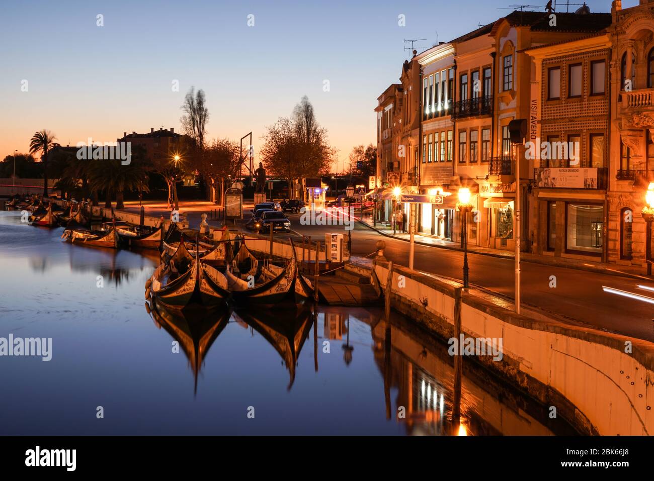 Aveiro, Portugal - April 2019: Tradicional Moliceiro boats docked in the main canal near Rossio after sunset. Stock Photo