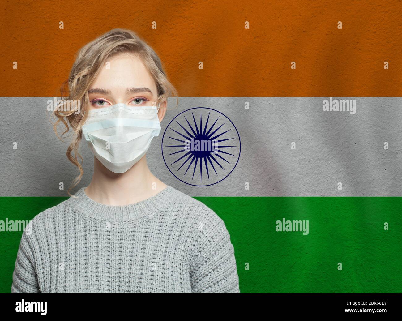 Young woman wearing a face mask with national indian flag. Flu epidemic and virus protection concept Stock Photo