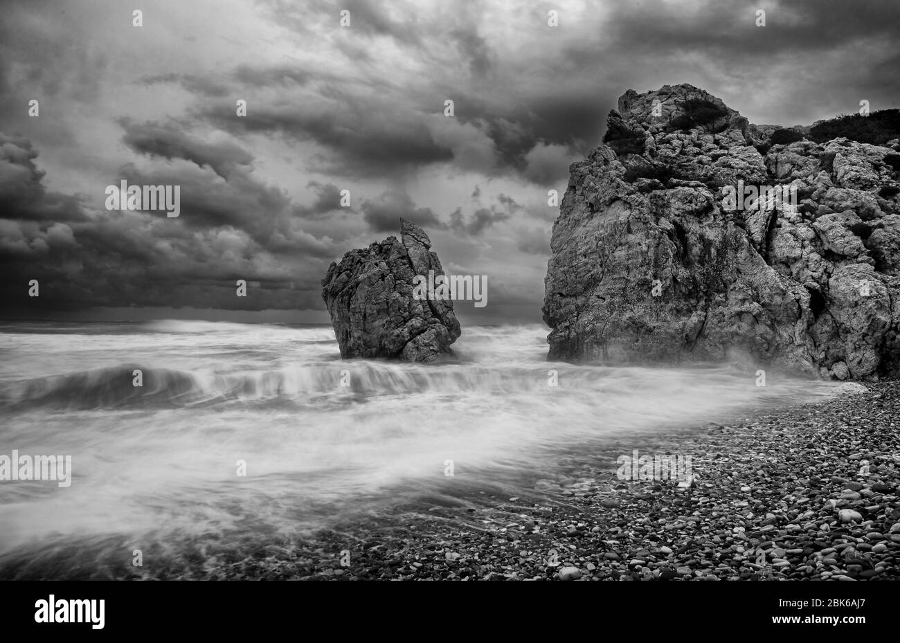 Seascape with windy waves during storm weather at the rocky coastal area of the Rock of Aphrodite in Paphos area, Cyprus. Longexposure Photography Stock Photo