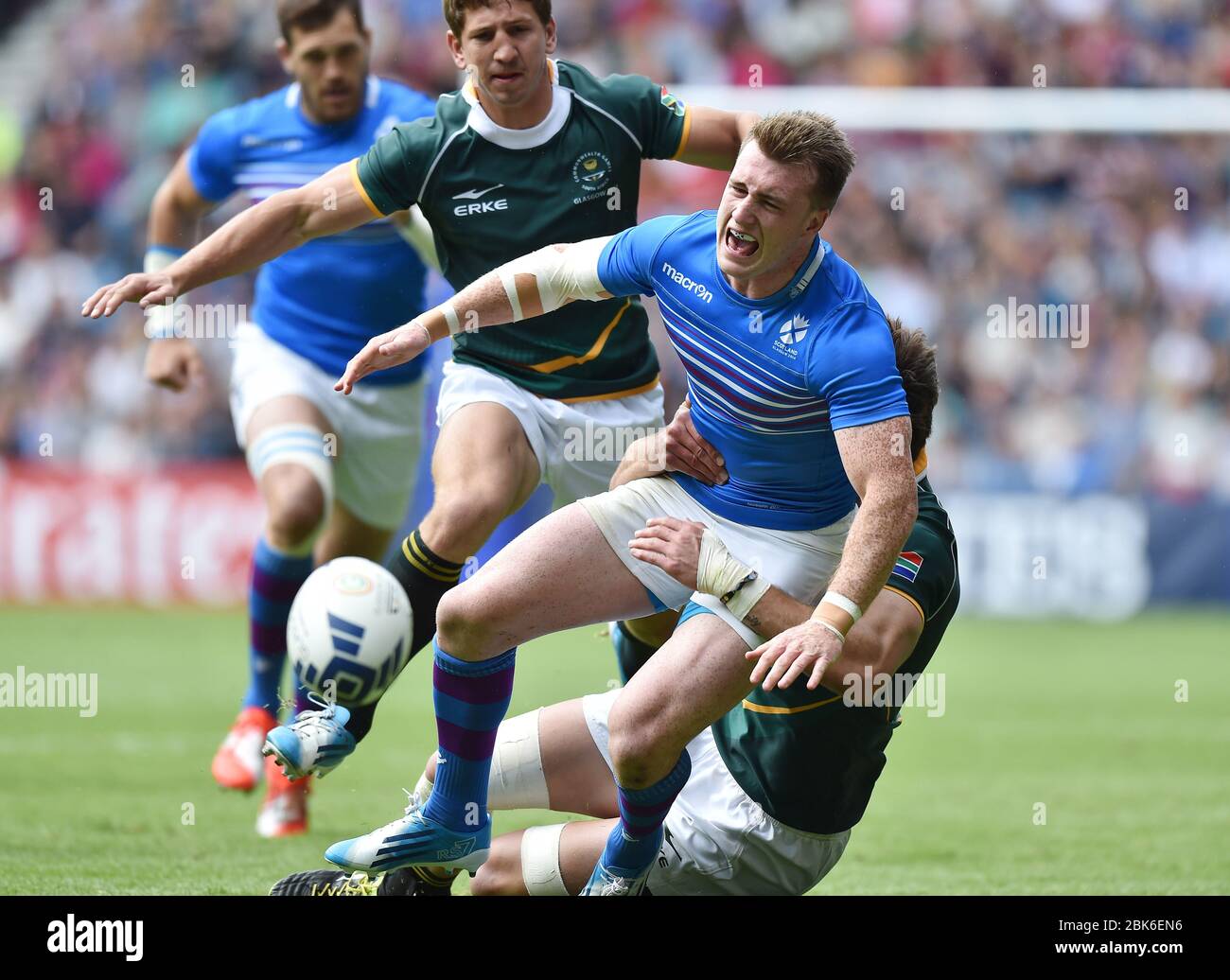 Scotland's Stuart Hogg is tackled by South Africa's Warren Whiteley during the quarter final tie. 2014 Commonwealth Games, Ibrox Stadium, Glasgow. Stock Photo