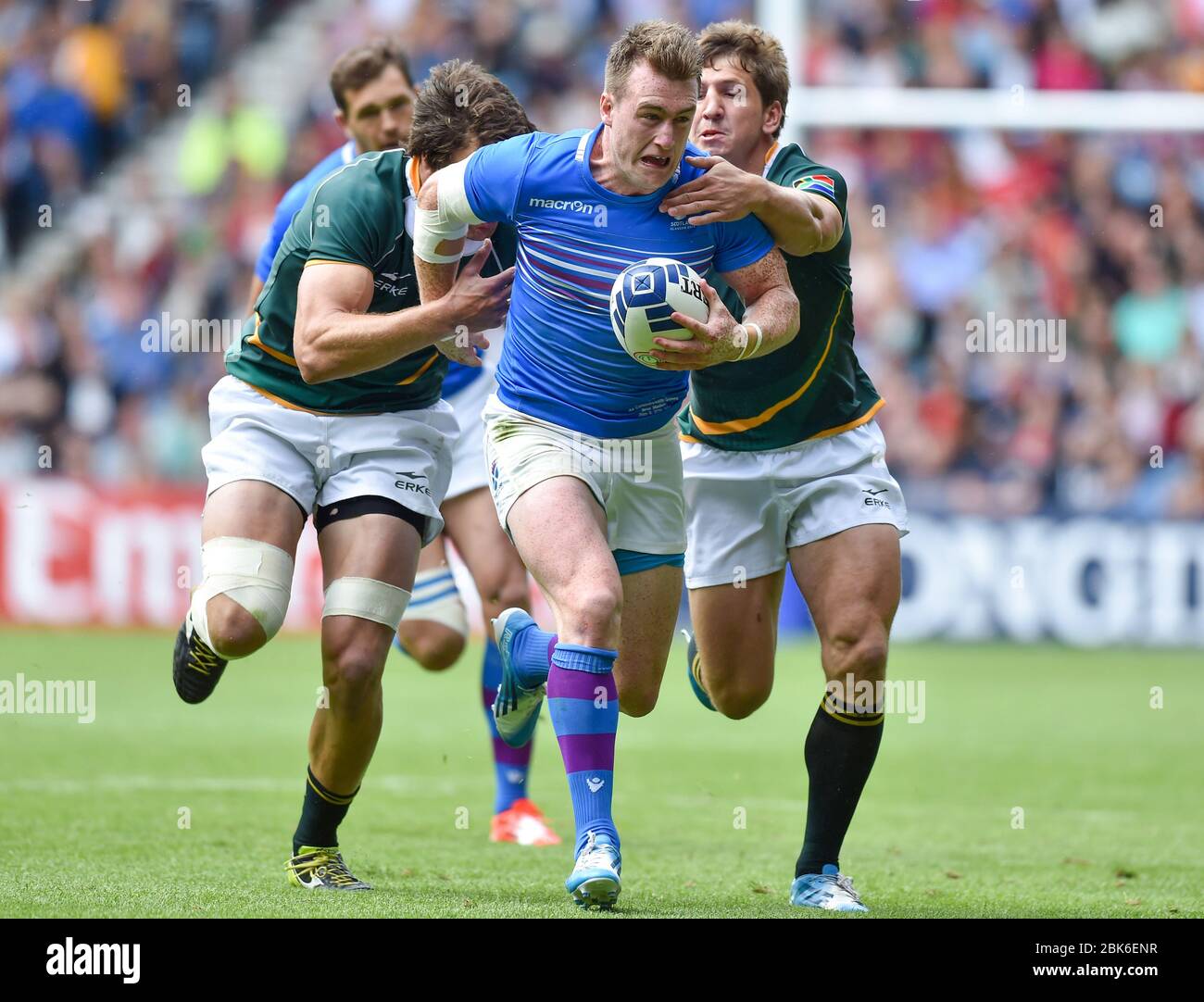 Scotland's Stuart Hogg is tackled by South Africa's Warren Whiteley and Kwagga Smith during the 2014 Commonwealth Games, Ibrox Stadium, Glasgow. Stock Photo
