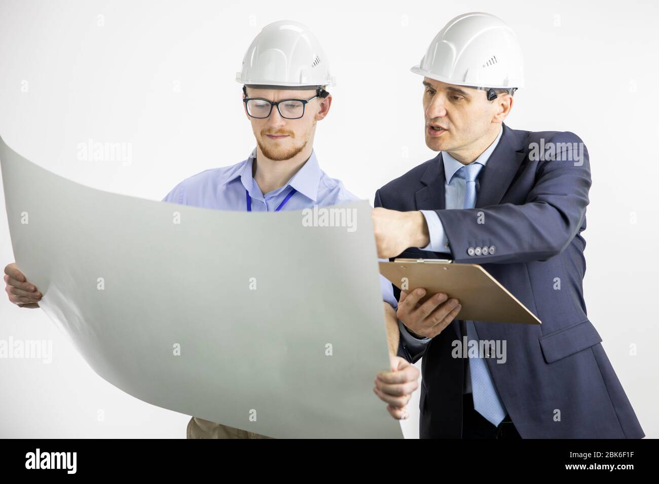 Architectural engineers working with blueprint documents on white background Stock Photo
