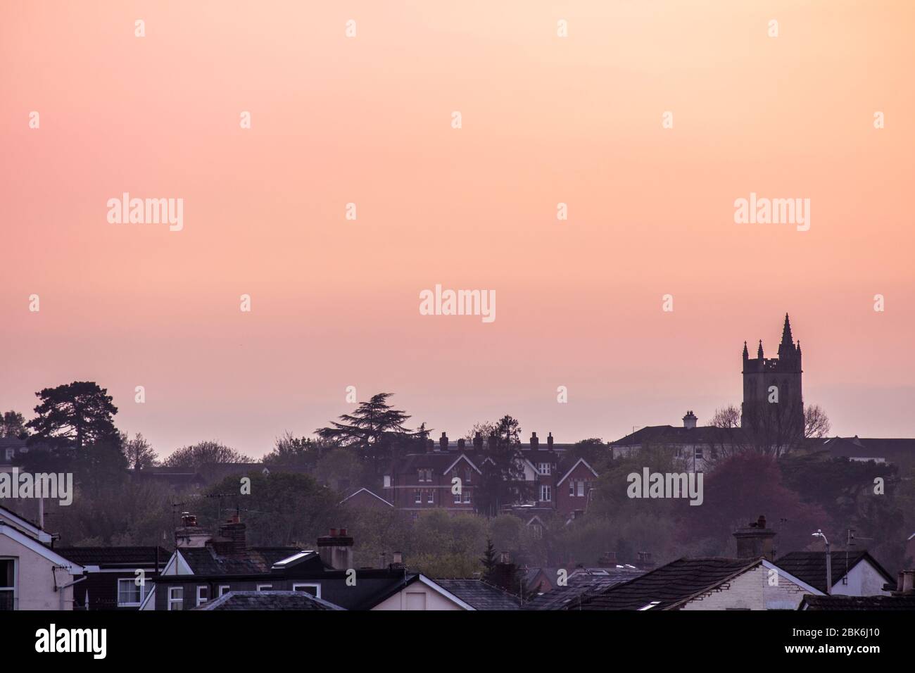 Tunbridge Wells Rooftops at sunset looking towards the spire at St Johns church once the sun had set and the sky turned orange & pink Stock Photo