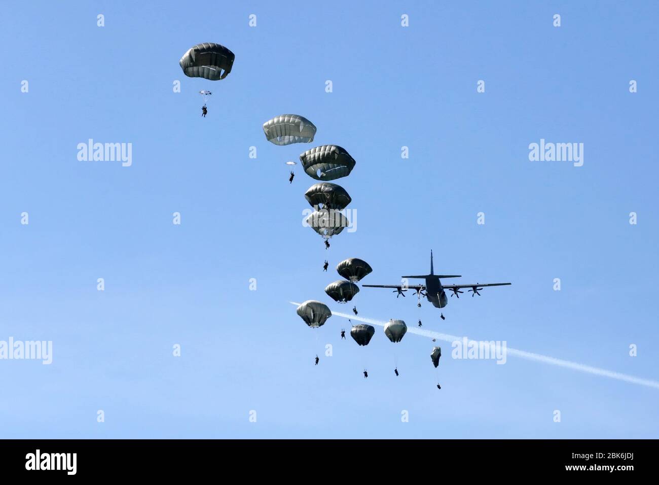 Military paratroopers jumping out of the transport plane Stock Photo