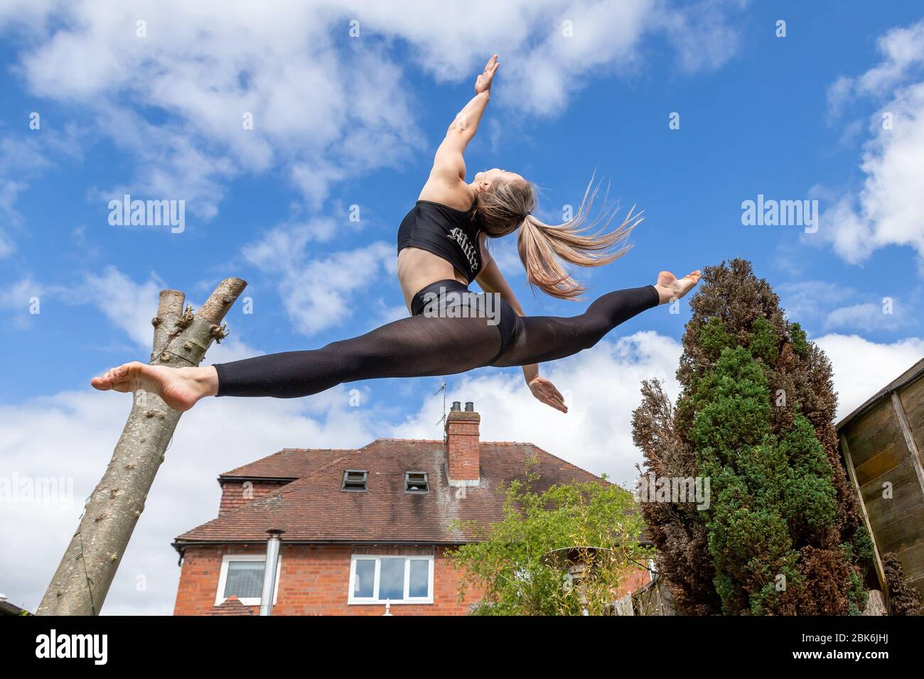 Halesowen, West Midlands, UK. 2nd May, 2020. 15-year-old Amelia Hubbard of Halesowen, West Midlands, is practicing her dance routines in her family's back garden. Gyms and dance studios will remain closed even after any lockdown is eased over the coming weeks. Amelia, like so many other dancers is relying on online classes to stay connected to her fellow students, and does up to seven hours practice a day. Credit: Peter Lopeman/Alamy Live News Stock Photo