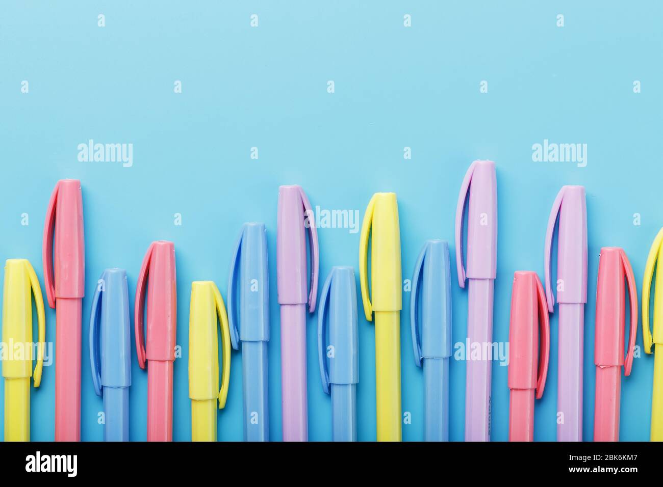 Multi-colored markers on a blue background with free space. Stock Photo