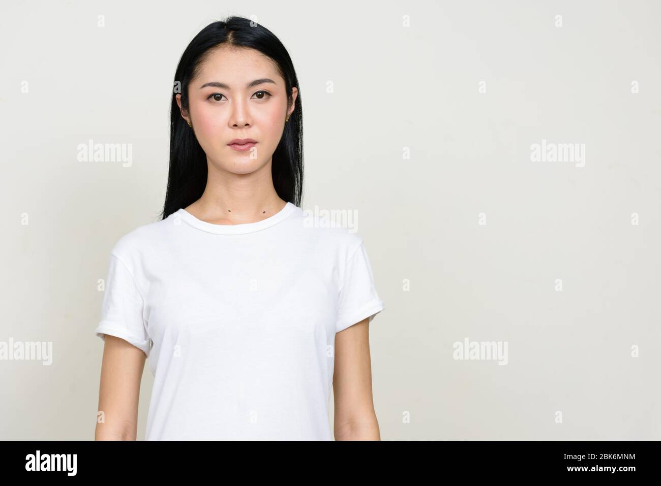 Portrait of young beautiful Asian woman looking at camera Stock Photo ...