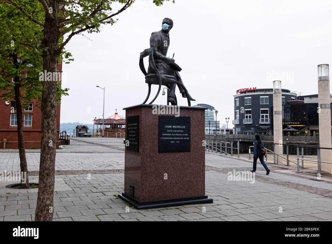 Statue of Welsh composer and actor Ivor Novello in Cardiff Bay, Wales, has his face covered with a face mask during the coronavirus COVID19 pandemic Stock Photo