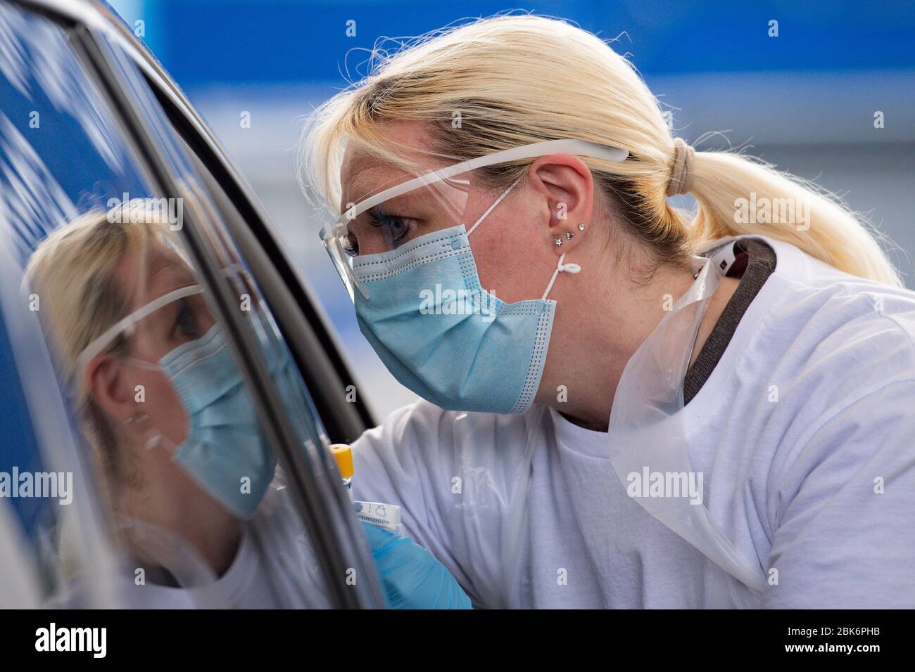 A person is tested for coronavirus at the drive through facility at the Edgbaston Cricket Ground Covid-19 testing site in Birmingham. Stock Photo