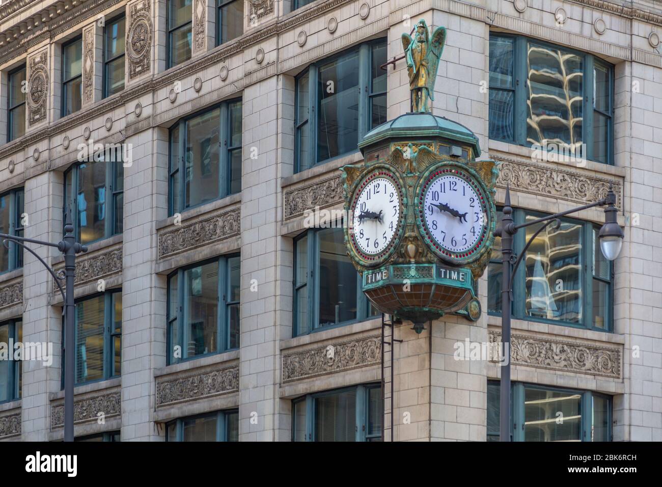 View of ornate clock on street corner, Chicago, Illinois, United States