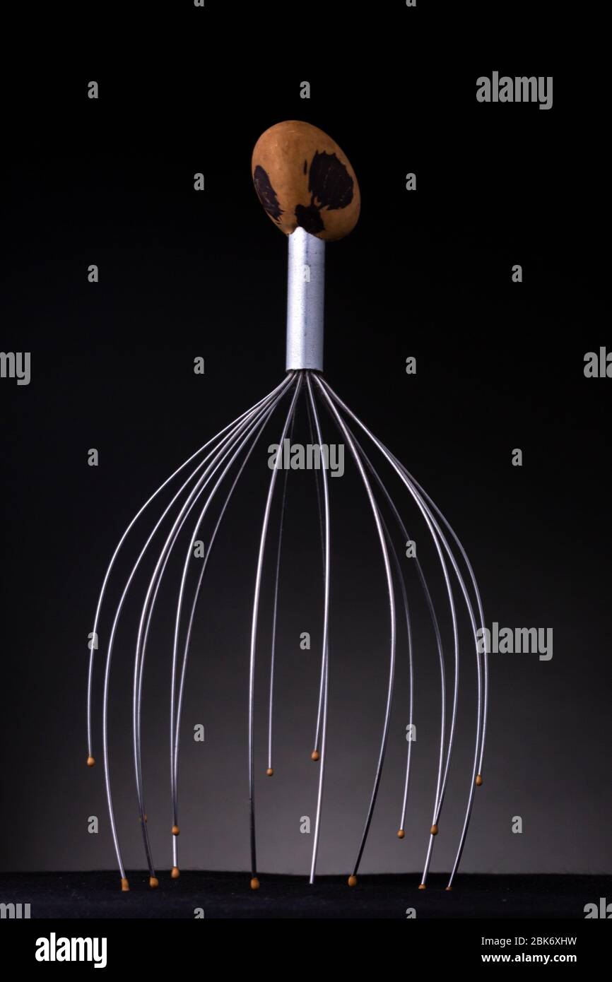 Brightly shining metal of a head massage tool with rounded tips and